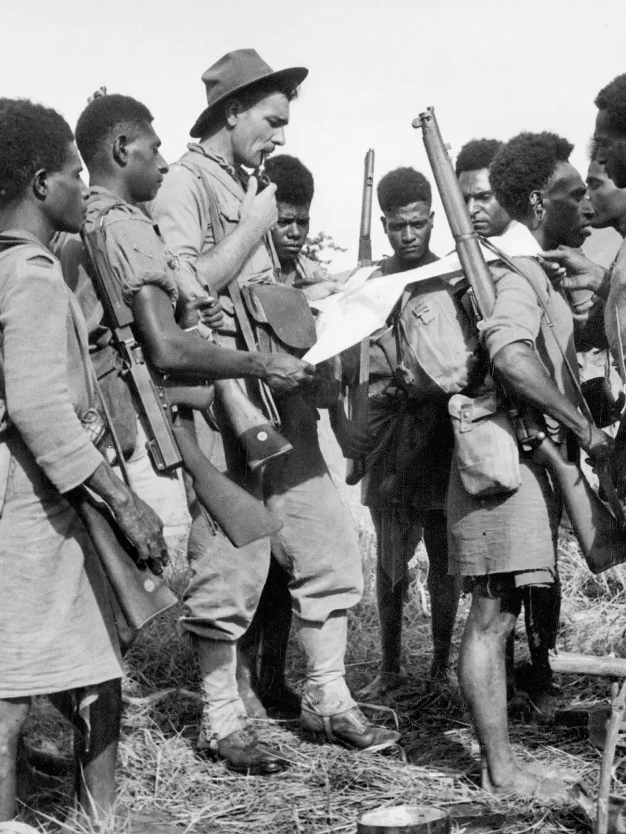 An Australian officer and a group of the 1st Papuan Infantry Battalion