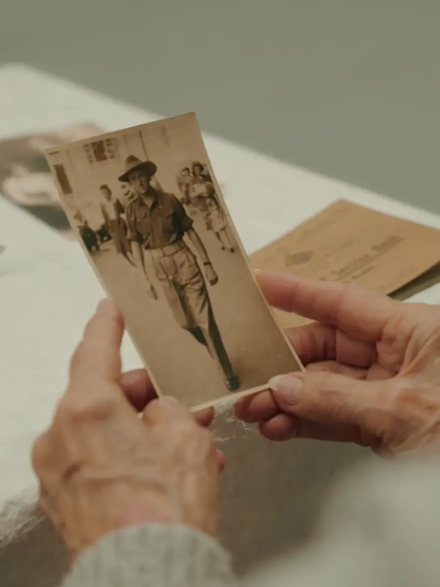 John’s niece, Rae Maree Curtis, studies a photograph of her uncle.