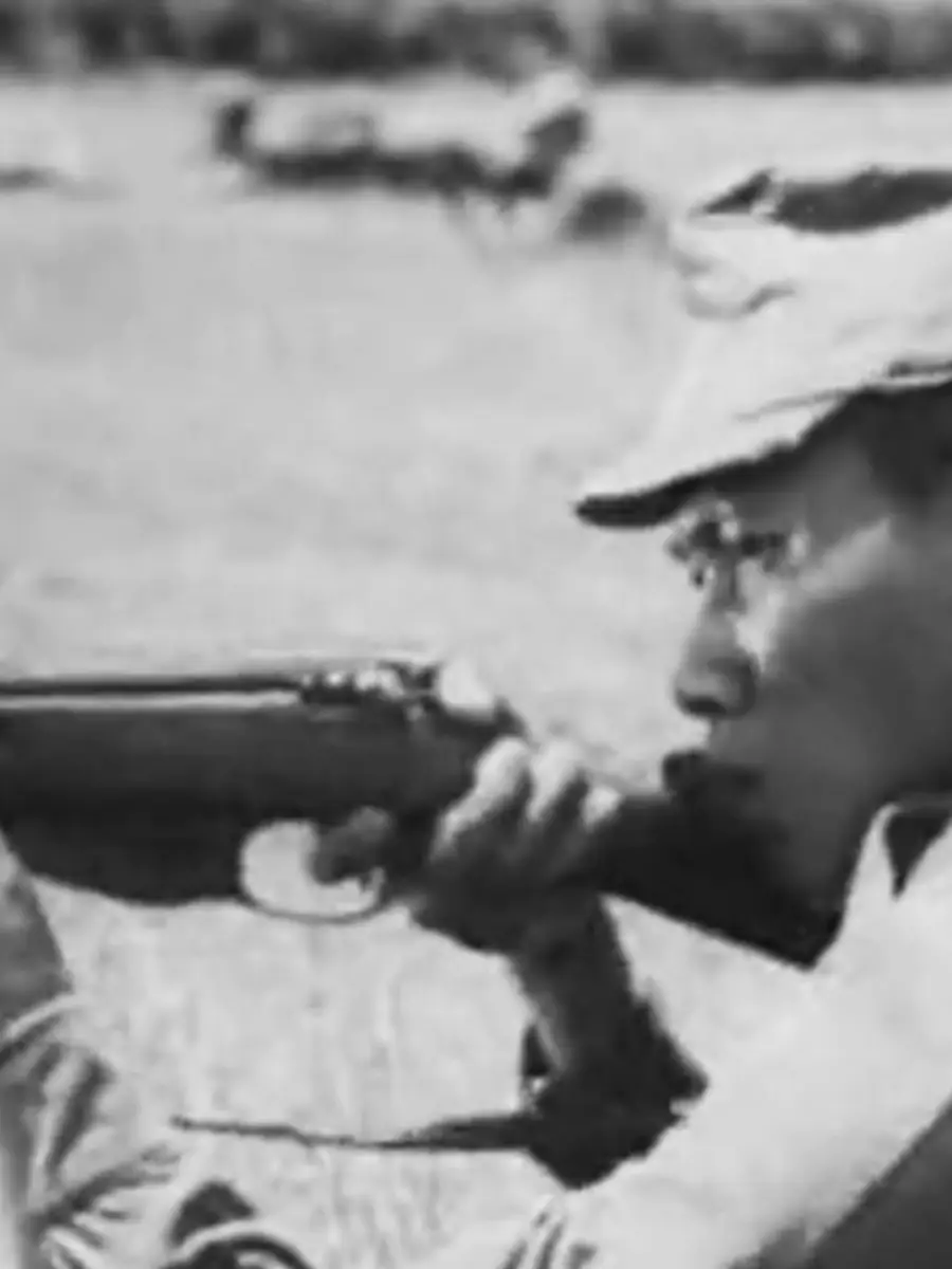 Japanese soldier points gun during military training video