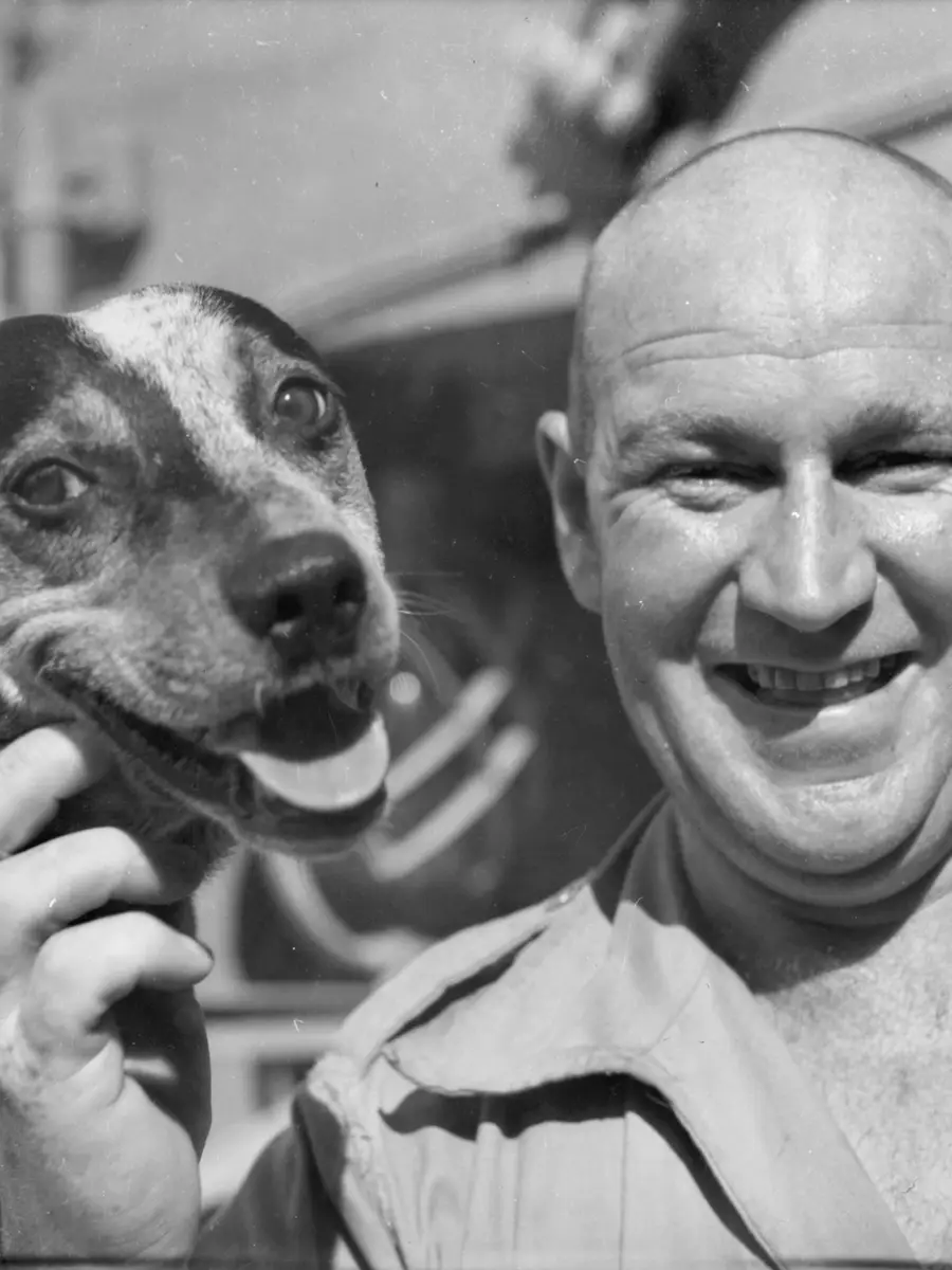 At sea from Fremantle - Pte George McCoullough 1st recovery section, 1st army field workshop with "Butch", the regimental dog that he and his pal Pte Archie Holmes brought from Sydney to Puckapunyal and then smuggled aboard.