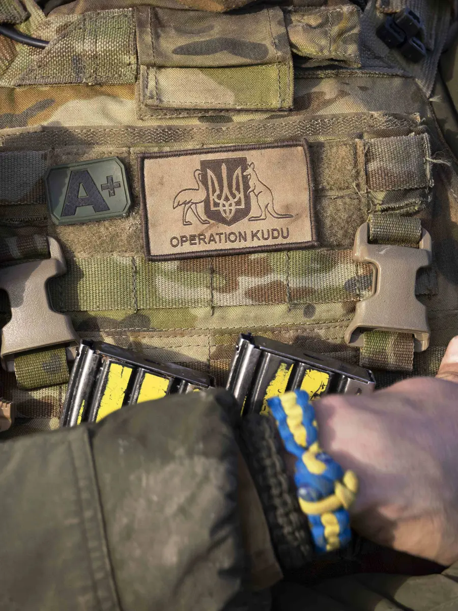 An Australian soldier wears an Operation Kudu patch and a braided Ukrainian friendship bracelet