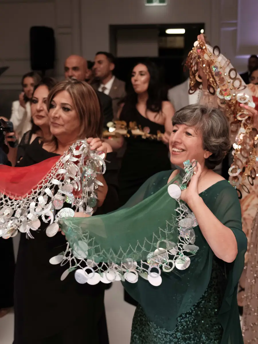•	Dancers with yalekhtas at an Assyrian wedding in Australia. Photograph by Sitto Studios.