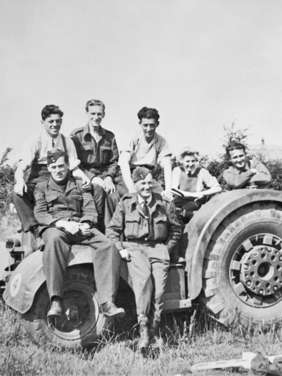 Ground maintenance crew of No. 463 Squadron RAAF posing on a RAF David Brown airfield tractor.