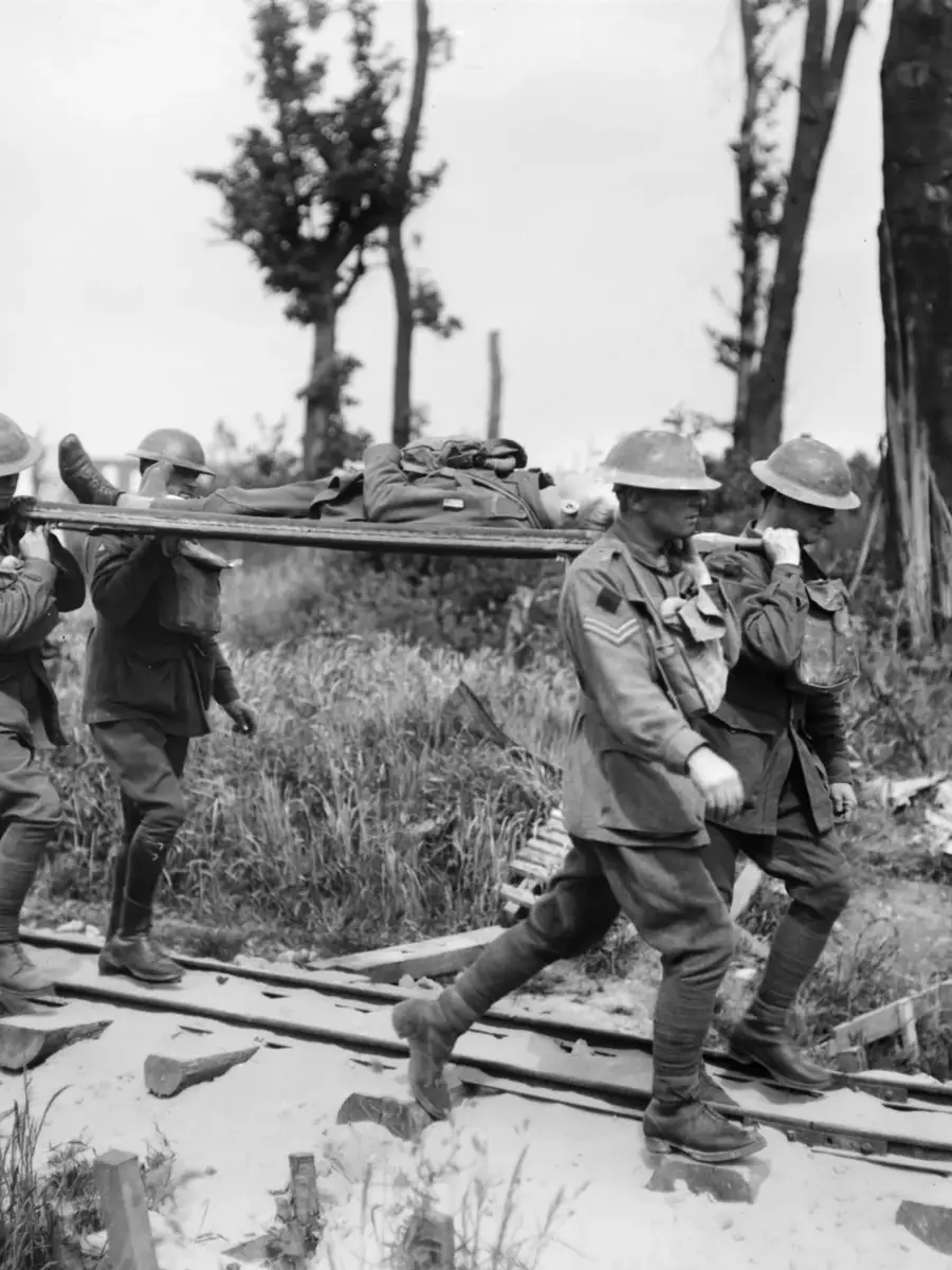 Four unidentified stretcher bearers of the 2nd Australian Division carrying a wounded soldier