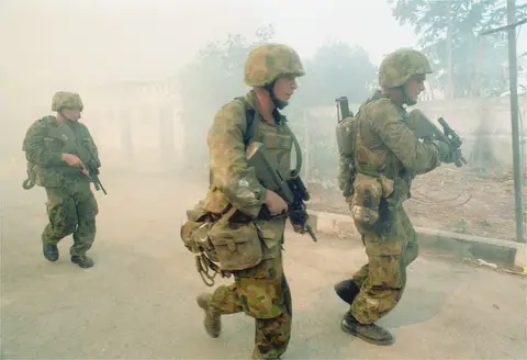 Soldiers from 3RAR conduct a cordon and search operation in Dili 24 September 1999