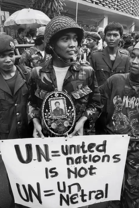 Protesters hold a sign in Jarkarta against the Australian-led International Force East Timor