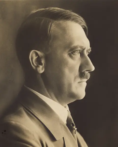 Side profile portrait of Adolf Hitler.
