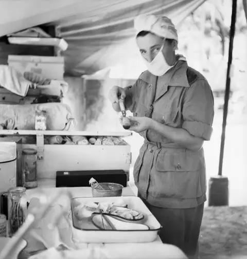 Lieutenant Ada McCulloch prepares a penicillin injection, Morotai, 1945