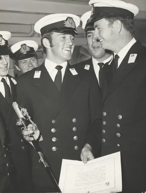 Holly’s father receiving the Jubilee Memorial sword on board HMAS Sydney