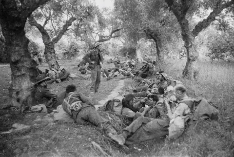 AUSTRALIAN TROOPS RESTING UNDER THE OLIVE TREES