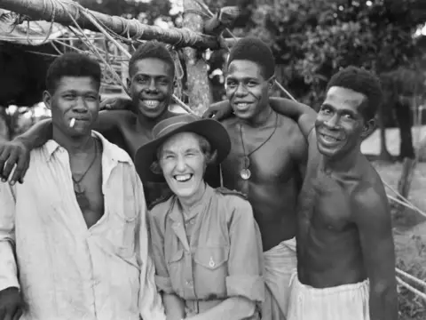 Senior Sister E.B.Y. Cameron with members of the Papuan Infantry Battalion
