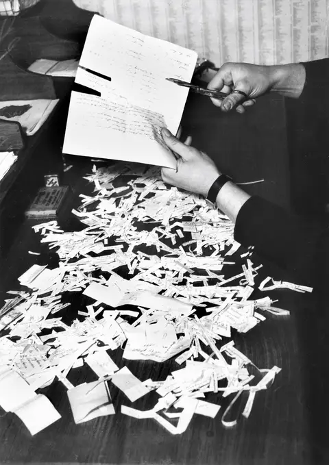 Mail censor cutting “indiscreet” material from a letter, Melbourne, 1943.  Photographer: Melbourne Herald. AWM  139316