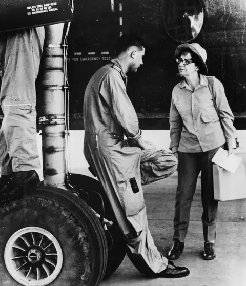 Australian war correspondent, Dorothy Drain speaking with RAAF Caribou flight crew at an air base during the Vietnam War. Photographer unknown.
