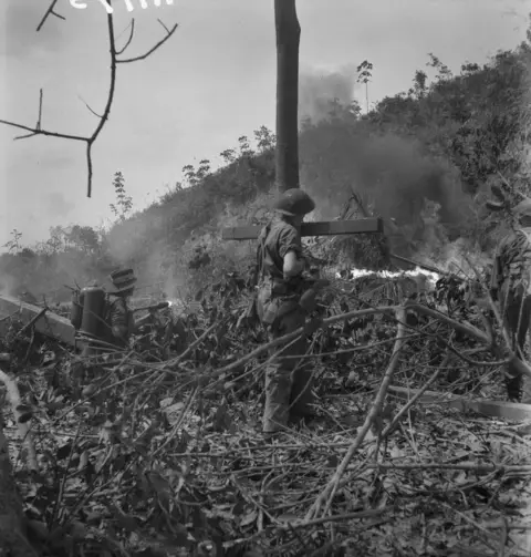 Men of the 2/16th Battalion use flamethrowers to clear Japanese snipers from a tunnel on Balikpapan, 1945