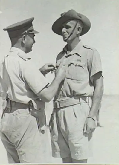 Sergeant Jack Weston, DCM, 2/48th Battalion, receiving the ribbon of the Military Medal from Lieutenant-General Sir Leslie Morshead in September 1942