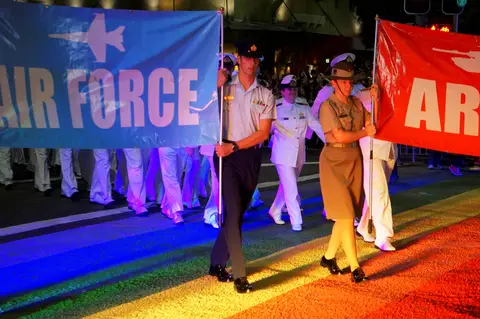 Members of the ADF’s inaugural Mardi Gras parade march over the ‘Rainbow Crossing’ in March 2013. 