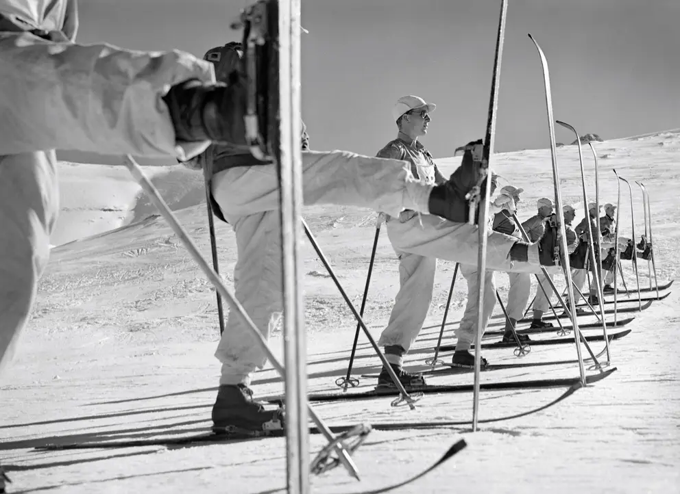 Members of the ski school line up to practice the kick turn.
