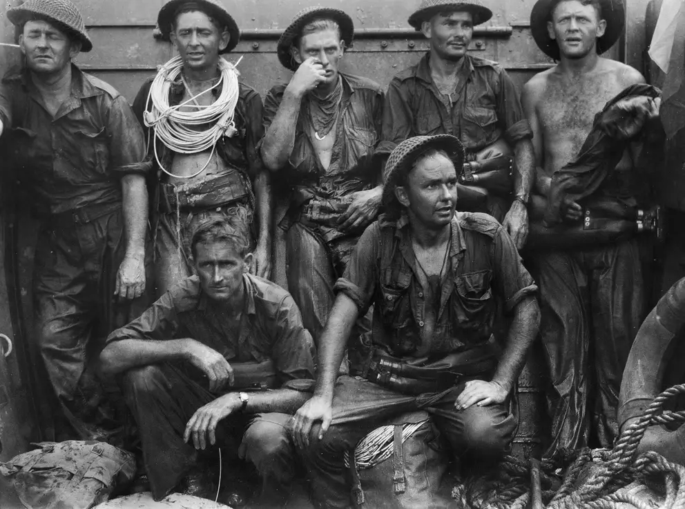 Members of the 2/3rd Field Company rest in a landing craft