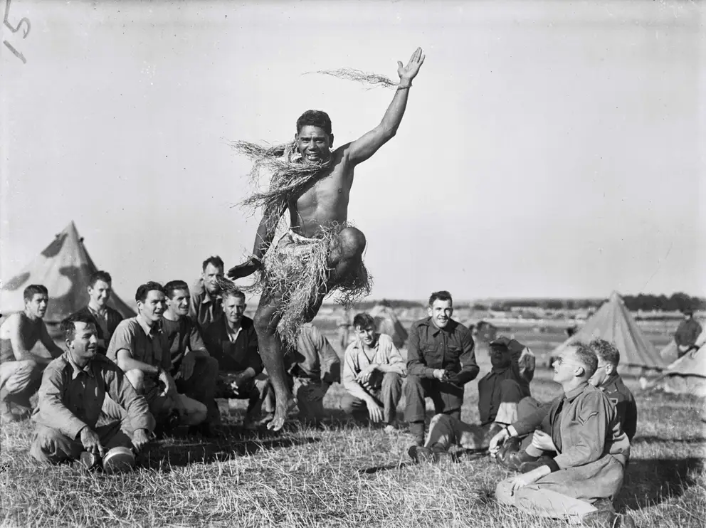 Private Victorianno (Victor) Blanco leaps in the air whilst wearing a traditional skirt