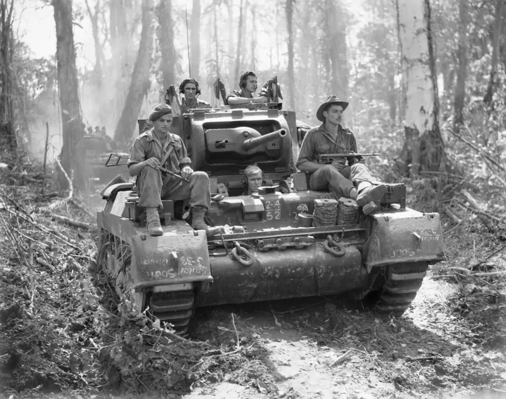 Soldiers ride a Matilda tank on the Buin Road