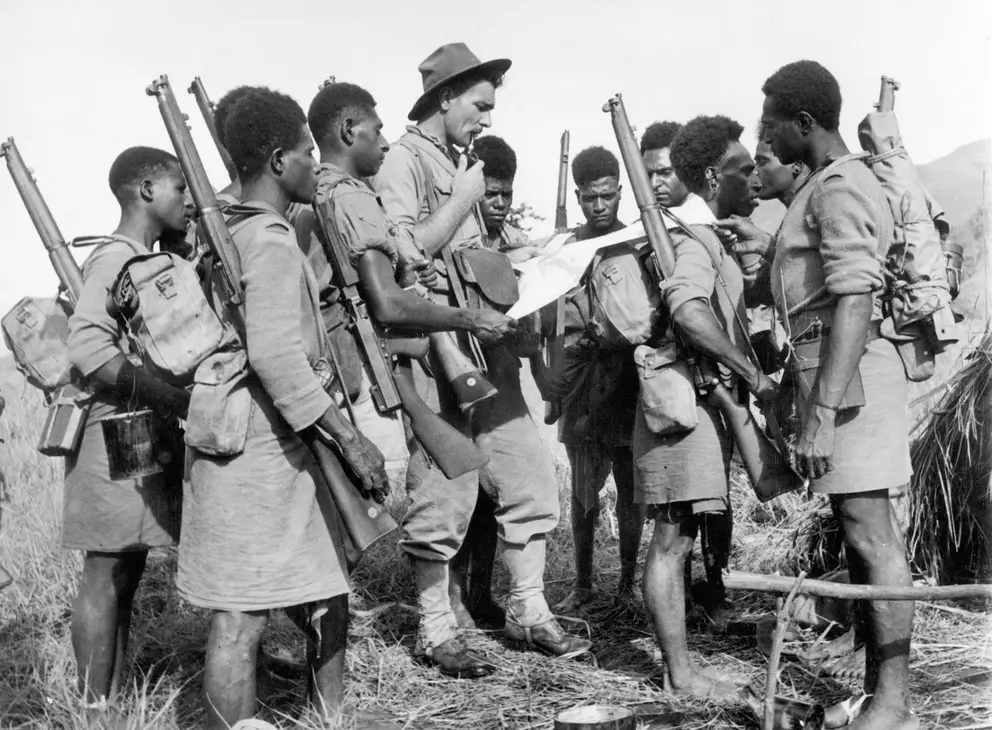 An Australian officer and a group of the 1st Papuan Infantry Battalion
