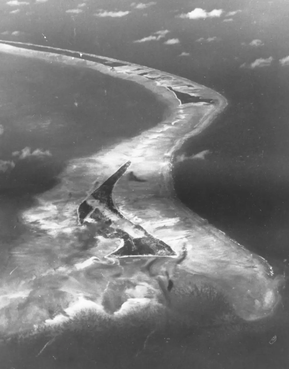 Aerial photograph of Betio 1943 with the triangular islet of Bairiki above. Photo credit Photo 80-G-83771 US Naval History and Heritage Command