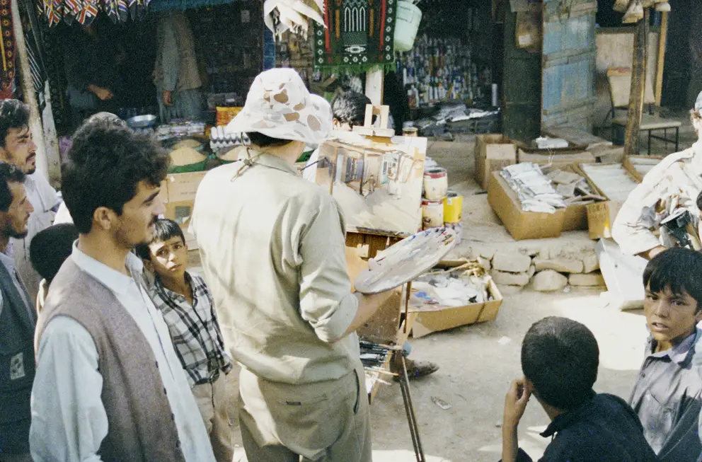 Peter Churcher painting SAS soldier in village at Bagram, September 2002